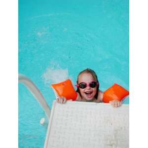  A Girl with Water Wings and Goggles in a Swimming Pool 