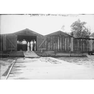 photo Crew team of Syracuse University in doorway of their boat house 