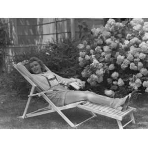  Young Woman Relaxing in Deckchair in Garden Photographic 