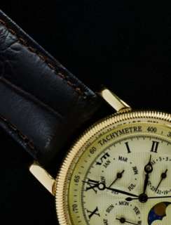 handsome Longines watch with a gold case, a black leather watchband 