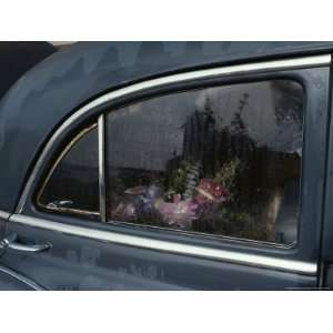Floral Arrangement Seen Through the Rain Spattered Window of a Car 